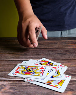 Midsection of man playing poker at table