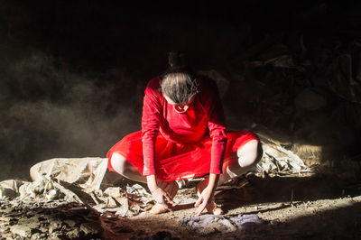 Full length of ballet dancer performing against wall in abandoned building