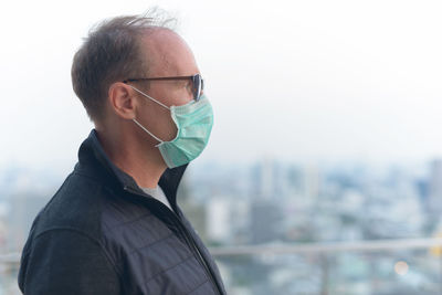 Portrait of man wearing eyeglasses against sky