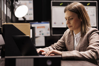 Young woman using laptop at table