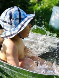 Full length of shirtless boy in water