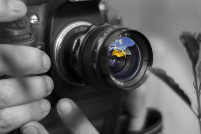 Close-up of cropped hand holding camera