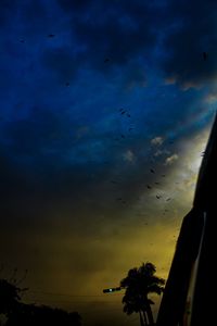 Low angle view of silhouette birds flying against sky