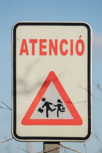 Low angle view of road sign against clear sky