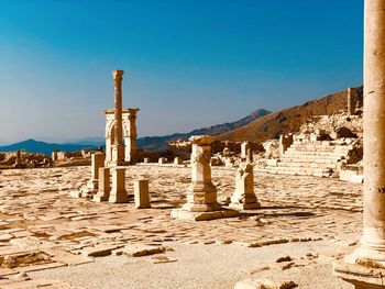 View of old ruins against clear blue sky