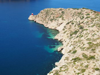 High angle view of rock formations by sea