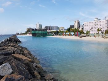 Panoramic view of sea and buildings against sky