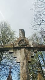 Low angle view of statue against bare trees