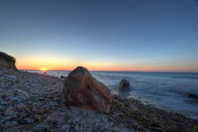 Scenic view of beach against sky during sunset