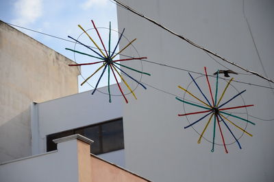 Low angle view of decoration hanging against sky