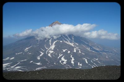 Scenic view of mountains against cloudy sky