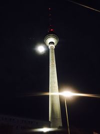 Low angle view of communications tower at night