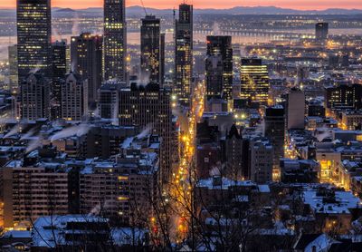 High angle view of illuminated cityscape at dusk