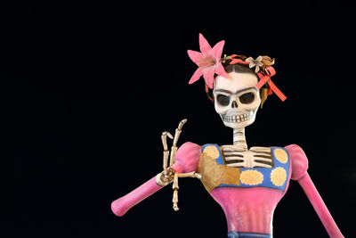 Close-up of pink toy against black background