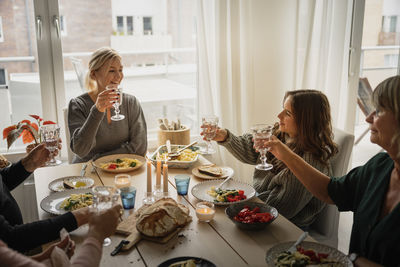 Family raising toast at dinner