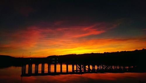 Silhouette of pier at sunset