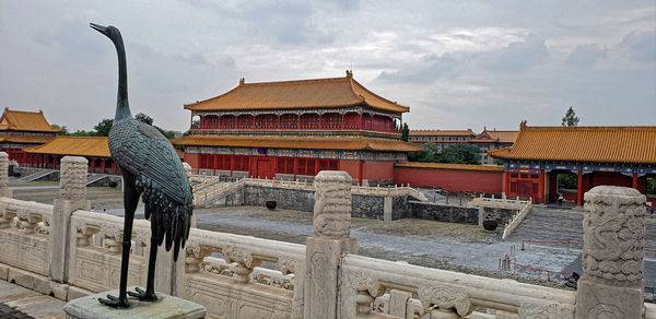 Sculpture of temple against building