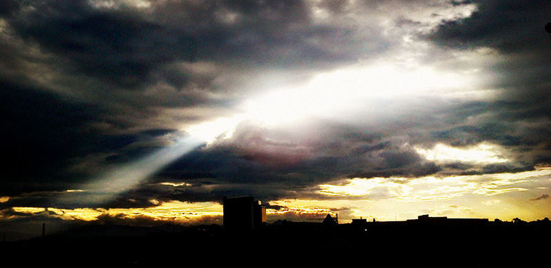 sunset, silhouette, sky, cloud - sky, cloudy, dramatic sky, low angle view, built structure, cloud, beauty in nature, scenics, architecture, building exterior, weather, nature, orange color, overcast, sun, sunlight, tranquil scene