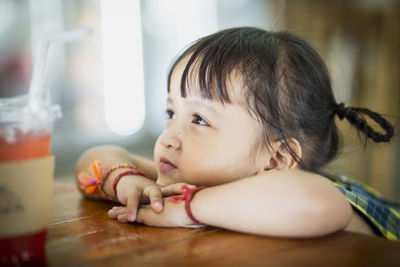 Close-up of cute baby girl at home