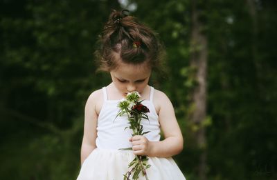 Midsection of woman holding flower