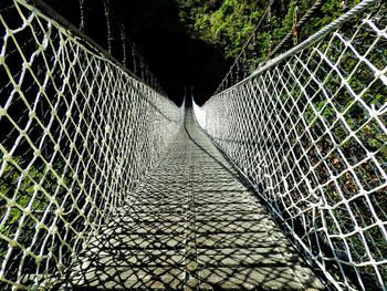 View of footbridge through chainlink fence