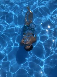 High angle view of boy swimming in pool