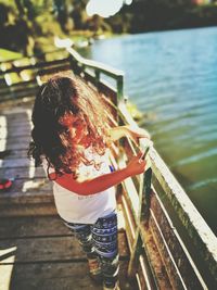 Rear view of girl standing in lake