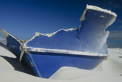 Snow covered mountain against blue sky