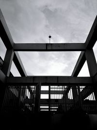 Low angle view of bridge against cloudy sky