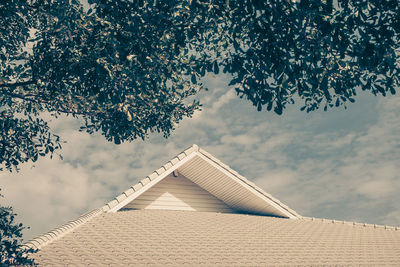 Low angle view of building against cloudy sky