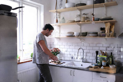 Mid adult man making chocolate truffles at kitchen counter