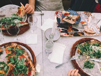 High angle view of pizza served in plate on table at restaurant