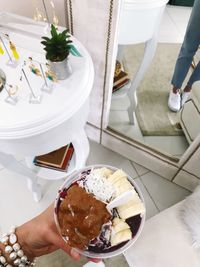 High angle view of woman holding ice cream in plate