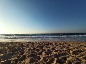 Scenic view of beach against clear sky