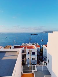 High angle view of buildings in sea against sky