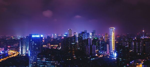 Aerial view of city lit up at night