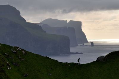 Scenic view of sea and mountains against sky