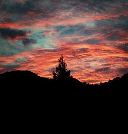 Silhouette of landscape against cloudy sky