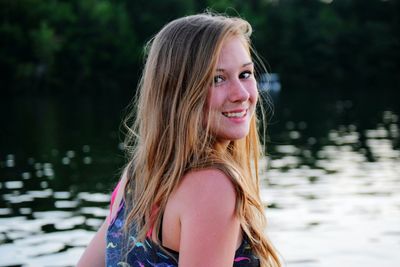 Portrait of smiling woman standing in water