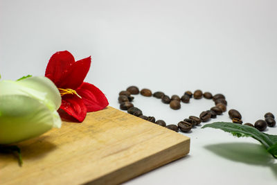 Close-up of red rose on table