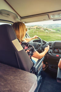 Unrecognizable woman traveling in camper van