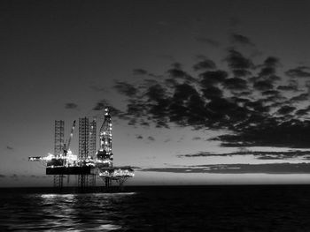 Scenic view of illuminated sea against sky