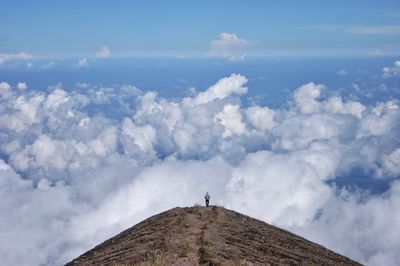 Man standing on mountain against sky