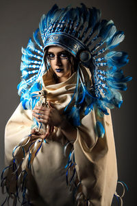 Portrait of woman holding blue painting