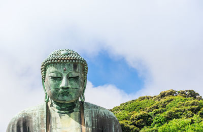 Statue of buddha against sky