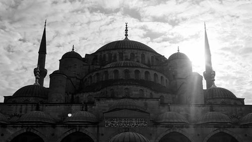 Low angle view of sultan ahmed mosque against cloudy sky on sunny day