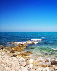 Scenic view of sea against clear blue sky