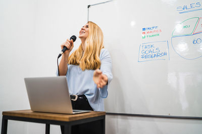 Businesswoman giving presentation in conference room