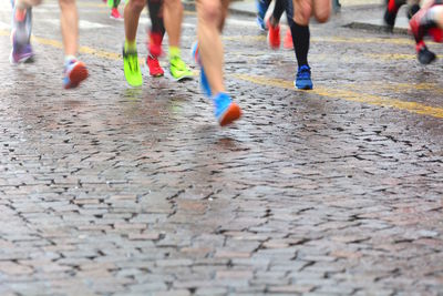 Low section of people running on street