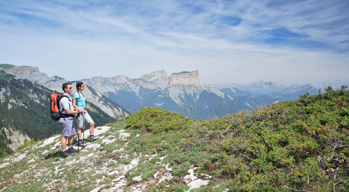 Man standing on mountain against sky